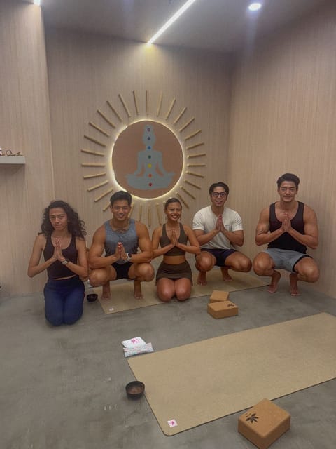 Joahnna in a low squat with four men after a group lesson